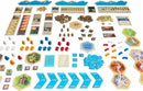 A colorful assortment of game components from Catan: Traders & Barbarians, including hexagonal tiles, cards, tokens, and resource pieces, arranged neatly for gameplay. Featuring various colors and shapes representing settlements, roads, and resources, the layout showcases the strategic elements of this popular board game.