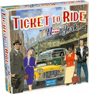 Ticket to Ride: New York board game from Days of Wonder. The box features colorful artwork depicting characters in 1950s attire set against a backdrop of New York's iconic skyline. A yellow taxi cab and vintage bus are visible, capturing the essence of city travel.