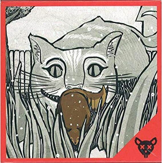 Box cover of the game 'Squirrel or Die' by Atlas Games. The artwork features a large, playful cat with wide eyes, holding a brown squirrel in its mouth, surrounded by tall grass and a whimsical, gray background.
