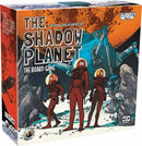 The Shadow Planet board game by Galakta. The box features vibrant artwork depicting astronauts exploring a mysterious landscape. Three characters in space suits stand in the foreground, while a large vehicle partially obscured by rocks looms in the background. The rich colors and dynamic scenes invite adventure and exploration.
