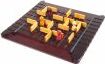 Quoridor game by Gigamic, showcasing a wooden game board with yellow and red pieces strategically placed. The objective is to navigate the red pawn to the opposite side while blocking opponents.