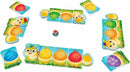 The Rainbow Caterpillar game by HABA features colorful puzzle pieces laid out on a bright, grassy area. Players can see charming animal characters and colorful caterpillar sections, alongside a multicolored dice, inviting a fun-filled gameplay experience for children.
