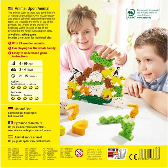 Children playing with the Animal Upon Animal game by HABA, featuring a colorful stacking challenge with 29 wooden animal figures. The game encourages precision as players stack the animals in a pyramid formation, showcasing collaboration and playful competition in a family-friendly setting.