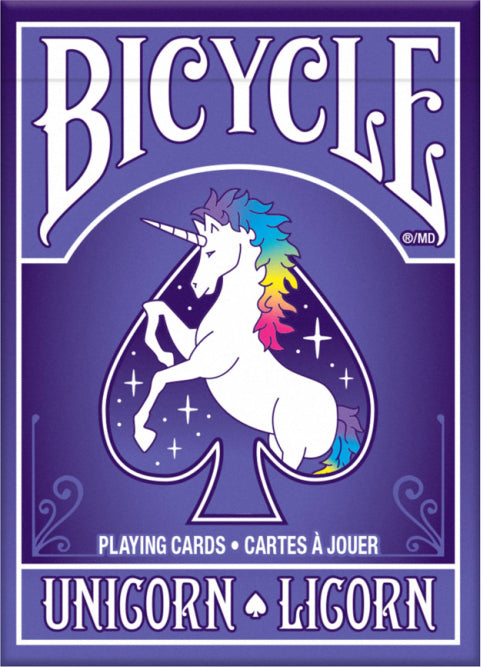 Bicycle Unicorn playing cards featuring a colorful unicorn with a rainbow mane on the front of the deck, set against a purple background with sparkling stars. The design includes 'Bicycle' in bold white lettering at the top, and 'Unicorn' in playful font at the bottom, highlighting its whimsical theme.