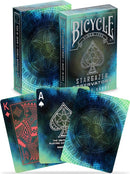 Bicycle Stargazer Observatory playing cards set, featuring a cosmic design with a starry background. The card backs display a unique floral pattern with vibrant blues and greens, while the top cards show a King of Diamonds and an Ace of Spades, all produced by the US Playing Card Company.