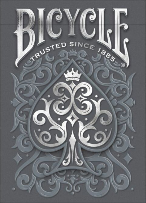 A beautifully designed Bicycle Cinder deck of playing cards, featuring an ornate gray background with a decorative spade symbol embellished with intricate designs. The top reads 'Bicycle' and 'Trusted Since 1885', showcasing the brand's classic and premium quality.