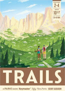 The box cover of the board game 'Trails: A Parks Game' by Keymaster Games. The illustration features two hikers enjoying a scenic view of mountains and lush greenery, highlighting the beauty of nature. The title 'TRAILS' is prominently displayed at the bottom, along with player details, ages, and game duration.