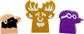 Three colorful game pieces from the Root: Underworld Hierlings Pack by Leder Games. The pieces include a character with a black beard, a moose-like figure with antlers, and a purple character wearing glasses. Each piece has a unique design and shape, ideal for enhancing gameplay.