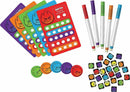 Colorful game components from Fiesty Dice by MindWare, featuring scoring cards in various colors, colorful markers, and playful dice with vibrant flame designs. The game is designed for group play, encouraging excitement and competition.