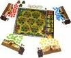 Garden Nation board game by BOMBYX displayed on a table, featuring a colorful forest theme with game pieces in red, blue, yellow, and green, alongside player boards and a central game board illustrating trees and pathways.