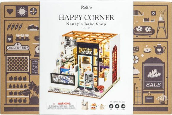 Nancy's Bake Shop DIY Miniature kit by Robotime. The product features a beautifully detailed bakery facade, vibrant colors, and intricate design elements, perfect for craft enthusiasts and miniature collectors.
