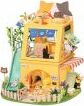 A detailed, colorful miniature cat house DIY kit by Robotime. The three-story structure features a cozy theme with a slide, flowers, and playful cat motifs. Perfect for cat lovers and DIY enthusiasts, this kit includes various components for creating a charming, interactive space for small pets.