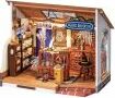 Kiki's Magic Emporium DIY kit by Robotime, showcasing a detailed miniature scene of a cozy emporium with shelves filled with magical items, a workbench, and charming decor, perfect for creative enthusiasts.