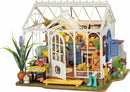 The Dreamy Garden House by Robotime is an intricately designed DIY kit showcasing a charming greenhouse filled with colorful plants, furniture, and decor. The model features a welcoming front porch with a yellow bench, vibrant flower pots, and decorative elements that create a cozy atmosphere. Inside, there are delightful details like painted wooden chairs, a rustic table, and playful gardening tools, all illuminated to enhance the enchanting garden theme.