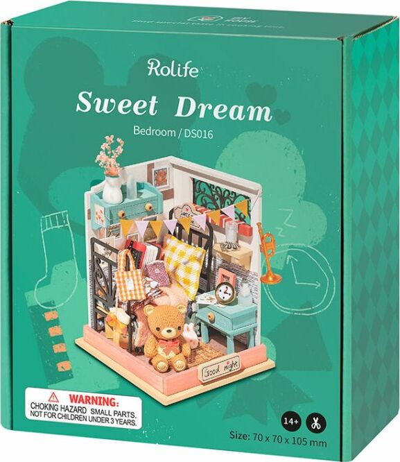 The Sweet Dreams Bedroom Model Kit by Robotime is a detailed DIY model kit featuring a cozy bedroom scene with a teddy bear, flower vase, books, and colorful decorations. The kit showcases intricate design elements including a desk, table, and various accessories, perfect for crafting enthusiasts aged 14 and up.