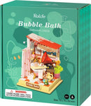 Bubble Bath Bathroom Model Kit by Robotime. This DIY kit features a detailed miniature bathroom with accessories like a shower curtain, plants, and decor items. Perfect for creative adults and older children aged 14 and above.