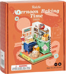 Robotime DIY Afternoon Baking Time kit featuring a colorful miniature kitchen scene. The box is adorned with illustrations of baking utensils and has a vibrant design. Inside, the setup includes a blue stove, green countertop, various baking supplies, and decorative items, ideal for creative DIY enthusiasts aged 14 and up.