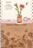 The Pink Carnation Model from Robortime is a DIY kit featuring 124 wooden pieces that can be assembled into a beautiful flower arrangement. The packaging displays the model of pink carnations in a decorative pot, emphasizing the theme of love and leisure. The artistic design includes various floral illustrations, appealing to crafters and flower enthusiasts alike.