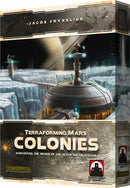 Box art for the board game Terraforming Mars: Colonies by Stronghold Games. The artwork depicts a futuristic colony on Mars, showcasing icy landscapes and advanced structures, inviting players to explore space colonization.