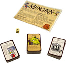 Munchkin game components including a rule sheet, a six-sided die, and three cards depicting characters and gameplay mechanics. The game emphasizes humorous role-playing and strategic gameplay.