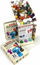 A colorful collection of collectible 'shrooms by TopDog Games, featuring three random designs in a vibrant box. The packaging highlights a variety of designs with a 'shroom decoder and displays details about each kind. The box is opened, revealing a mix of shiny and textured miniature mushroom figures in various colors, including purple, blue, and green, alongside a mixed assortment of stones and gems.