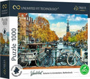 A beautifully illustrated 1000-piece jigsaw puzzle titled 'Wanderlust: Autumn in Amsterdam' by Trefl. The box features a picturesque Amsterdam canal scene, showcasing vibrant autumn foliage, historic buildings, and bicycles parked along the canal. The image captures the essence of fall in Amsterdam, with a clear sky and a tower in the background.