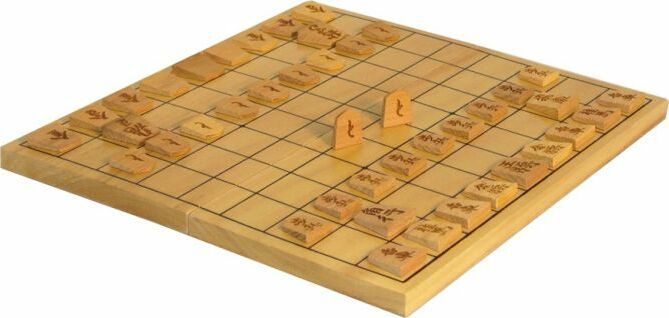 A beautifully crafted folding Shogi set featuring a wooden board with a grid pattern. The set includes intricately designed wooden pieces displayed on the board, arranged for play. Ideal for traditional Japanese strategy gaming, this set is perfect for both beginners and experienced players.