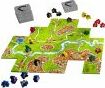 Carcassonne 20th Anniversary game by Z-Man featuring a colorful landscape with roads, cities, and a river. The board is surrounded by player tokens in various colors and scoring markers.