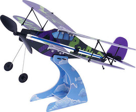 A colorful rubber band airplane model is displayed on a cloud-themed stand. The airplane features vibrant shades of purple and green, showcasing a unique design, and is equipped with a propeller and wheels, ideal for educational activities in aerodynamics and engineering for kids.