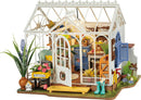The Dreamy Garden House by Robotime is a charming DIY kit featuring a detailed miniature greenhouse. The design showcases vibrant flowers, a welcome sign, gardening tools, and a cozy interior with colorful furniture. This delightful model captures the essence of a tranquil garden space, perfect for hobbyists and craft enthusiasts.