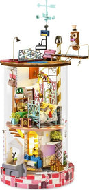Bloomy House Model Kit by Robotime is a beautifully detailed DIY kit that simulates a charming house interior with vibrant colors, intricate furniture, and decorative elements. It features a welcoming atmosphere with a cozy living area, colorful staircase, and an owl figure perched on top, making it a delightful project for enthusiasts of model building and creativity.
