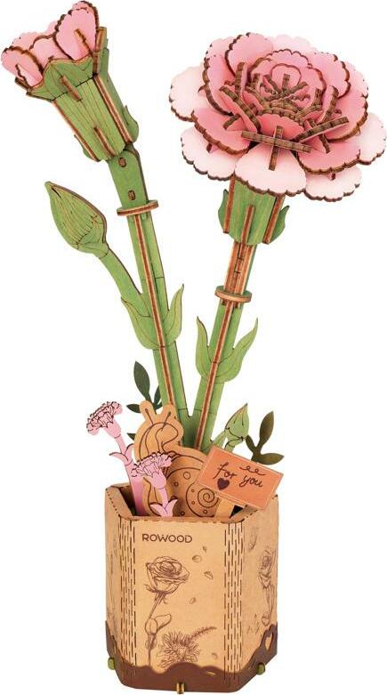 A beautifully crafted DIY kit featuring a pink carnation model. The kit includes intricately designed pink flowers and green leaves emerging from a decorative pot. It captures the essence of a floral arrangement made from high-quality materials, promoting creativity and craftsmanship.