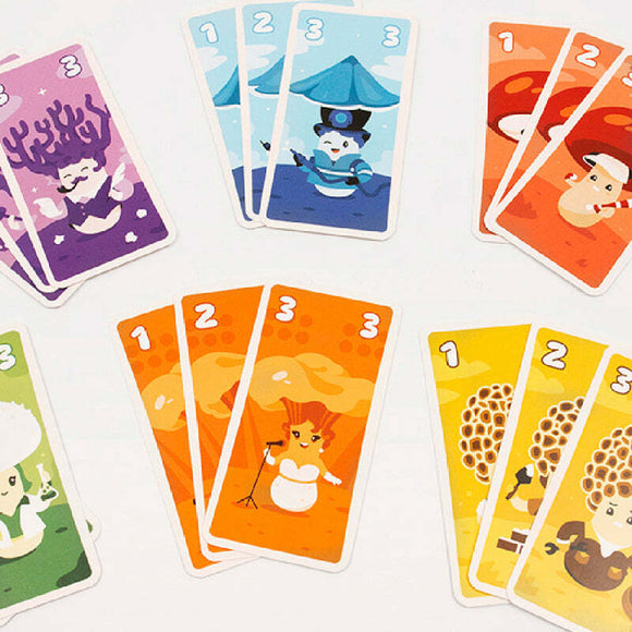 A colorful assortment of game cards from Kinoko by Helvetiq. The cards feature whimsical illustrated characters like a snowman in a top hat, vibrant mushrooms, and a singing snow figure, showcasing numbers prominently at the top. The design is playful and perfect for family-friendly games.