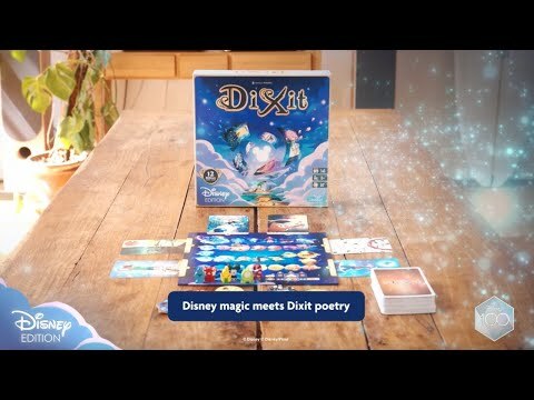 Dixit Disney Edition board game by Libellud displayed on a wooden table. The game box features whimsical Disney-themed artwork. Surrounding the box are game components, including colorful cards and a game board, suggesting an engaging gameplay experience that celebrates Disney magic and storytelling.