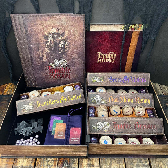 A detailed view of the game 'Blood on the Clocktower' by Pandemonium Institute. The image shows the game box open, displaying compartments filled with colorful tokens, cards, and character boards. The design features dark, immersive artwork with the title prominently displayed, alongside sections labeled 'Travellers & Fabled', 'Sects & Violets', and 'Had Aborn Rising'. The overall aesthetic is mysterious and captivating, perfect for game enthusiasts.