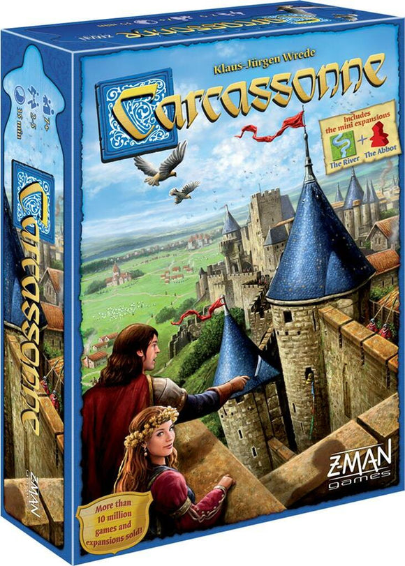 Carcassonne board game by Z-Man Games featuring detailed artwork. The box shows two characters in medieval attire looking at a castle with high towers and lush landscapes in the background. The packaging includes indications of mini expansions The River and The Abbot.