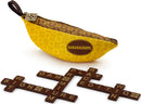 The Bananagrams Signature Edition game features a bright yellow banana-shaped pouch with a brown interior. The pouch is designed to hold game tiles, which are arranged on a surface to spell out words. The tiles are dark brown with letters visible, forming words such as 'Bananagrams' and 'Signature Edition'. This engaging word game promotes fun and creative gameplay suitable for all ages.
