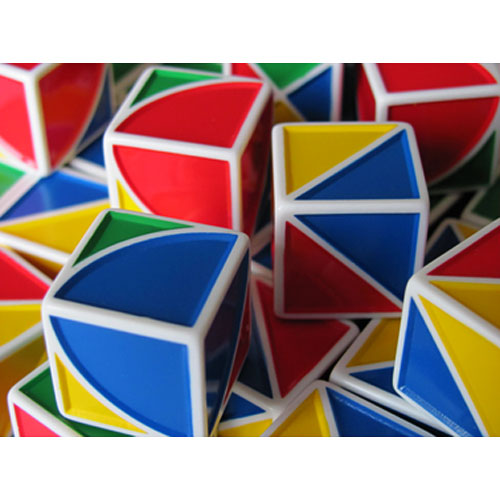 A colorful assortment of Pixy Cubes, featuring various geometric shapes and vibrant colors including blue, red, yellow, and green. Each cube has unique triangular and semicircular segments, showcasing a mechanical puzzle design that challenges spatial reasoning and creativity. The cubes are arranged in a chaotic yet visually appealing manner, inviting interaction and play.