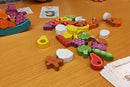 Buffet  Boss game in progress: wooden vegetables loose and stacked on dish