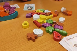 Buffet  Boss game in progress: wooden vegetables loose and stacked on dish