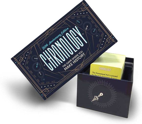 Chronology board game by Buffalo Games, featuring a sleek design with a dark blue and gold color scheme. The box displays the title 'Chronology' prominently, alongside a subtitle that reads 'The Game Where You Make History'. The game box is partially open, revealing an inner compartment with yellow game cards. The game's theme focuses on historical events and timelines, perfect for history enthusiasts and game lovers.