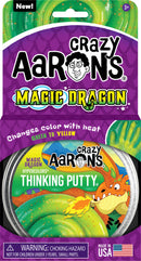A 4-inch tin of Crazy Aaron's Thinking Putty in Magic Dragon color, featuring vibrant green and yellow hues that change with heat. The packaging includes a playful dragon design, indicating the putty's ability to transform color, with a warning about small parts for children under three. Perfect for fidgeting and creative play.