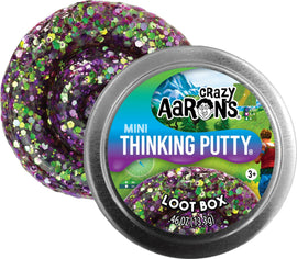 A colorful Mini Loot Box Trend 2" by Crazy Aaron featuring purple glittery thinking putty. The putty is showcased in a round tin container with a vibrant label, indicating its fun and engaging nature.