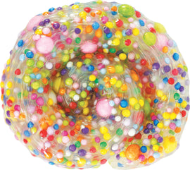 A close-up view of Thinking Putty Poke'n Dots from Crazy Aaron. The putty is transparent with colorful, assorted dots and sprinkles of different sizes and textures embedded within. This vibrant putty invites tactile exploration and creative play.