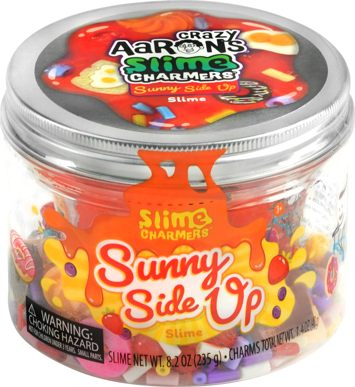 A colorful container of Crazy Aaron's Sunny Side Up Slime Charmers. The transparent jar showcases various fun slime charms including mini donuts, candy pieces, and colorful beads. The label features vibrant graphics and emphasizes the playful nature of the product, making it appealing for children aged 3 and up.