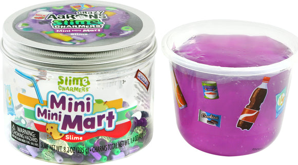A transparent jar labeled 'Mini Mini Mart Slime Charmers' filled with colorful slime and small charm beads. The slime is bright purple with various fun food stickers around the container. The jar is part of Crazy Aaron's Slime Charmers collection, suitable for ages 3 and up.
