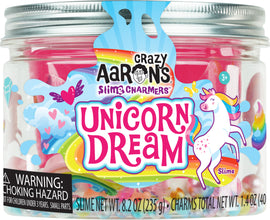 A colorful jar of Unicorn Dream Slime Charmers by Crazy Aaron's, featuring vibrant pink, blue, and yellow slime with whimsical charms inside. The label showcases a playful unicorn and a rainbow, highlighting the fun and imaginative aspect of the product. The jar contains 8.2 ounces (235 g) of slime, ideal for creative play and sensory experiences.