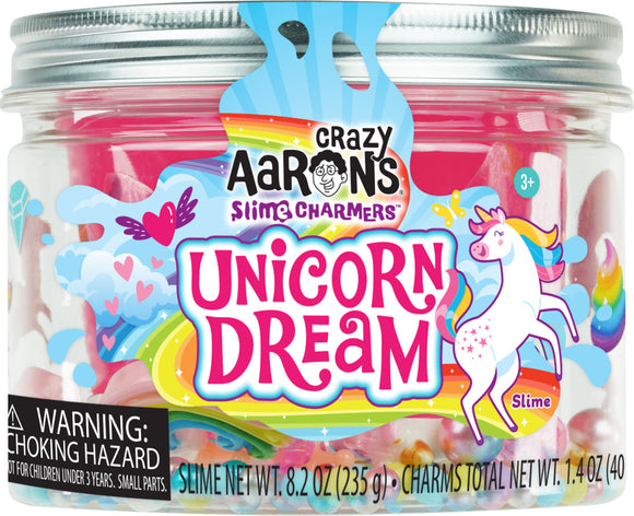 A colorful jar of Unicorn Dream Slime Charmers by Crazy Aaron's, featuring vibrant pink, blue, and yellow slime with whimsical charms inside. The label showcases a playful unicorn and a rainbow, highlighting the fun and imaginative aspect of the product. The jar contains 8.2 ounces (235 g) of slime, ideal for creative play and sensory experiences.