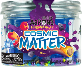 A colorful jar of Cosmic Matter Slime Charmers by Crazy Aaron. The jar features a vibrant label with space-themed graphics like planets, asteroids, and rockets, and contains blue slime with assorted charms, suitable for children ages 3 and up.