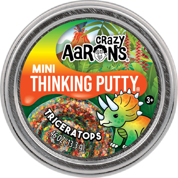 A vibrant 2-inch mini Thinking Putty container labeled 'Mini Triceratops' by Crazy Aaron. The lid features a colorful triceratops dinosaur illustration surrounded by green leaves, suggesting a playful and imaginative theme. The putty inside is speckled with sparkles and has a lively, colorful appearance.